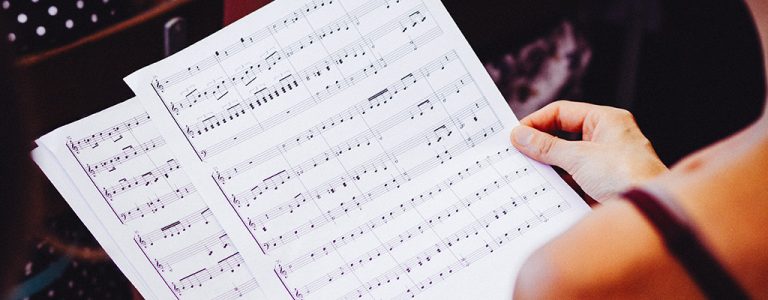 A female musician looking at sheet music